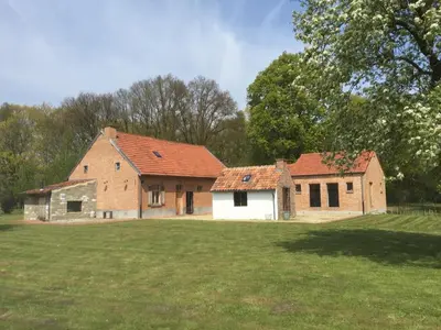 an old brick house in the middle of a field at Art Of Einstein in Diest