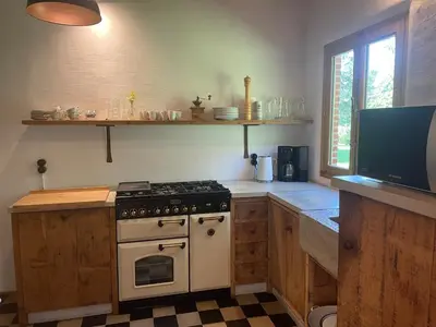 a kitchen with a stove and a tv in it at Art Of Einstein in Diest