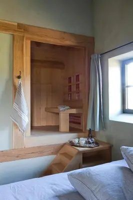 a bedroom with a bed and a desk and a window at B&B de ZIL in Herselt