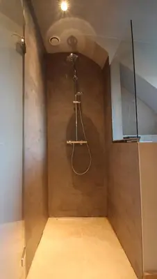 a bathroom with a shower in a room with a ceiling at B&B de ZIL in Herselt
