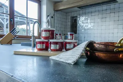 a kitchen counter with jars and a bowl of food at B&B de ZIL in Herselt