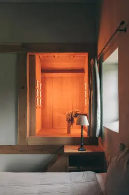 a bedroom with a bed and a desk with a lamp at B&B de ZIL in Herselt