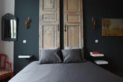 a bedroom with a bed with a large wooden door at Villa 36 B&B in Brussels