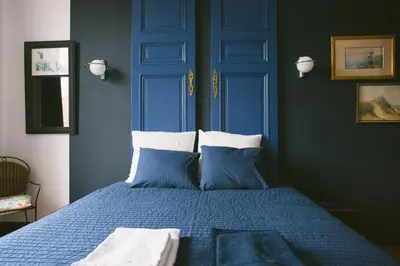 a blue bedroom with a bed with blue walls at Villa 36 B&B in Brussels