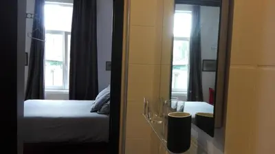 a bedroom with a bed and a mirror at Villa 36 B&B in Brussels