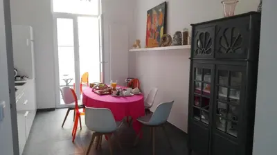 a dining room with a pink table and chairs at Villa 36 B&B in Brussels