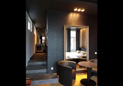 a room with a mirror and a table and chairs at Hotel Goodnight Antwerp in Antwerp
