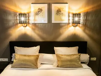 a bedroom with a bed with lights on the wall at Hotel Goodnight Antwerp in Antwerp