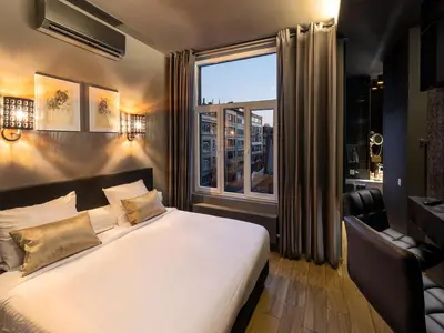 a bedroom with a large bed and a window at Hotel Goodnight Antwerp in Antwerp