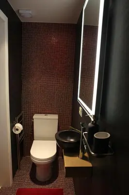 a bathroom with a white toilet and a sink at ZevenVrijeDagen in Ghent