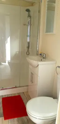 a bathroom with a toilet and a sink and a shower at Lake Park in Berlare
