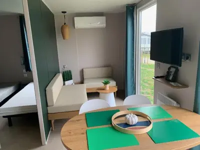 a living room with a table and a living room with a couch at Lake Park in Berlare