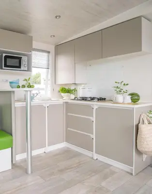 a kitchen with white cabinets and a counter top at Lake Park in Berlare