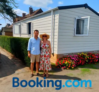a man and a woman standing in front of a house at Lake Park in Berlare