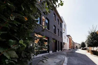 a ivy covered building on a city street at Befour in Aalst