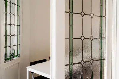 a room with a bed and a table with a window at Befour in Aalst