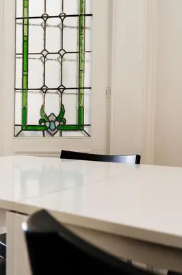 a table and a chair in front of a window at Befour in Aalst