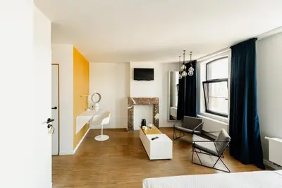 a living room with a couch and chairs in it at Befour in Aalst