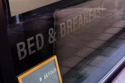 a bed and breakfast sign in a window at Befour in Aalst