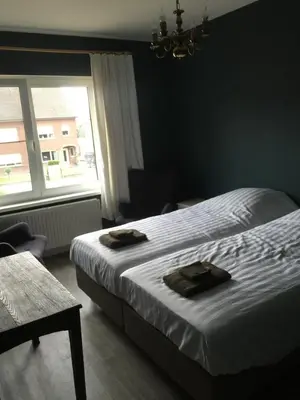 a bedroom with a bed with two towels on it at Holiday Home near town in Aarschot