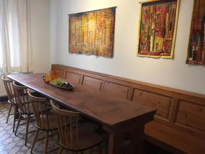 a dining room table with chairs and paintings on the wall at Holiday Home near town in Aarschot