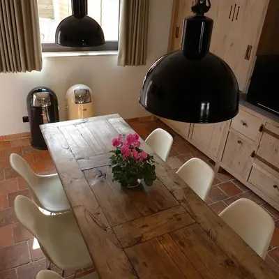 a dining room table with a vase of flowers on it at CitytripGent Apartment in Ghent