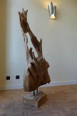 a wooden sculpture sitting on a block in a room at CitytripGent Apartment in Ghent