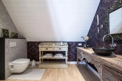 a bathroom with a sink and a toilet at B&B Vinedo in Zele