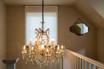 a chandelier hanging from a staircase in a house at B&B Vinedo in Zele