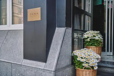 two baskets of flowers on the side of a building at The Legacy by 2GO4 City Center in Brussels