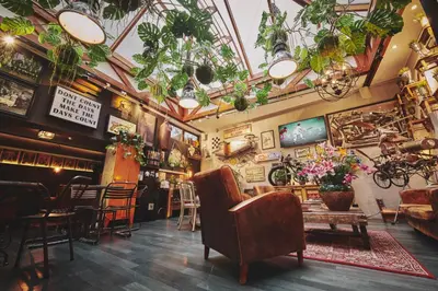 a restaurant with plants hanging from the ceilings at The Legacy by 2GO4 City Center in Brussels