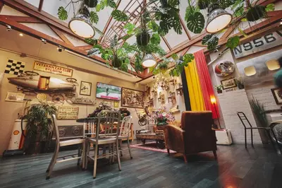 a room with chairs and plants on the walls at The Legacy by 2GO4 City Center in Brussels