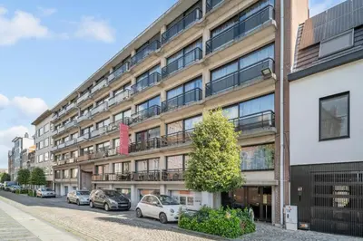 an apartment building with cars parked in front of it at Value Stay Residence Mechelen in Mechelen