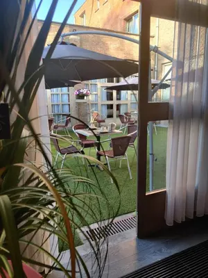 a balcony with a table and chairs and an umbrella at De Basiliek in Edegem