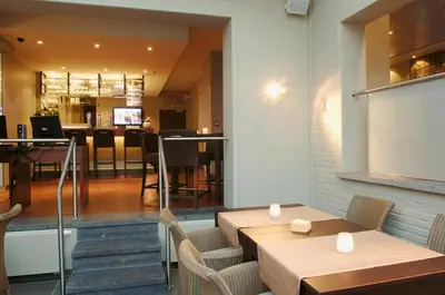 a restaurant with tables and chairs and a dining room at Hotel de modern in Diest
