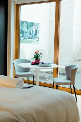 a room with a table and chairs and a window at The House of Edward by Domani Hotels in Ghent
