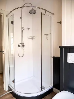 a shower with a glass enclosure in a bathroom at Maison Willem Tell in Ghent