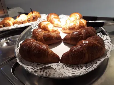 a tray filled with croissants and other pastries at Irish College Leuven in Leuven