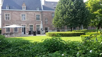a large brick building with an umbrella in front of it at Irish College Leuven in Leuven