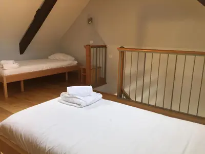 a bedroom with two white towels sitting on a bed at Irish College Leuven in Leuven