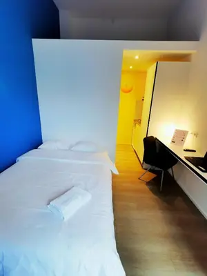 a bedroom with a white bed and a desk at Ooostel2.be Zaventem in Zaventem