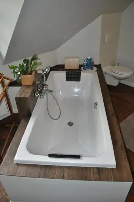 a large white bath tub in a bathroom at B&B L'Eau Claire in La Hulpe