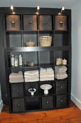 a black closet with black shelves and baskets at B&B L'Eau Claire in La Hulpe