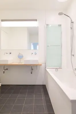 a bathroom with two sinks and a mirror at Hof Van Spanje in Ghent