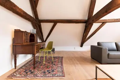 a living room with a desk and a chair at Hof Van Spanje in Ghent