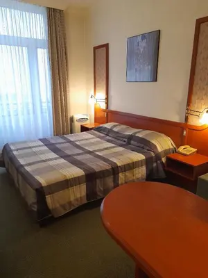 a hotel room with a bed and a table at Hotel Le Dome in Brussels