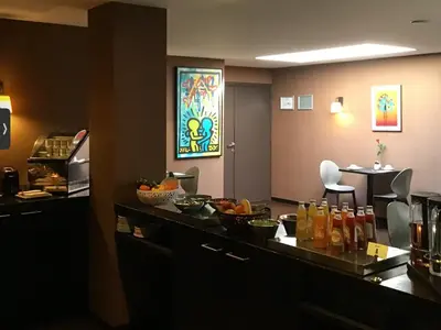 a bar in a hotel room with fruit on a counter at New Hotel Charlemagne in Brussels