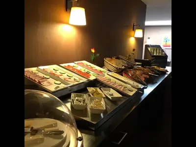 a buffet line with many different types of food at New Hotel Charlemagne in Brussels