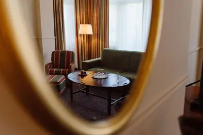 a living room with a couch and a coffee table at Park Hotel Brussels in Brussels