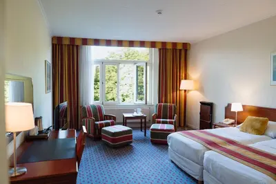 a hotel room with a bed and a window at Park Hotel Brussels in Brussels